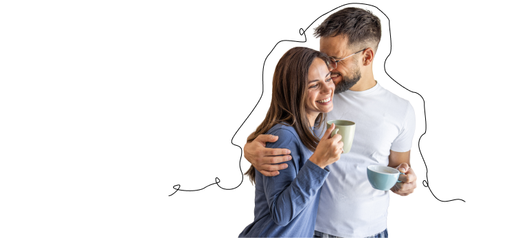 Couple smiling and holding cups of coffee